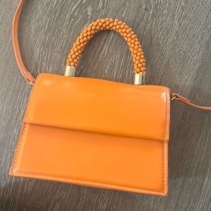 Orange Zara beaded top handle orange mini bag with adjustable cross body strap.